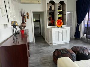 a living room with a couch and a table at Vaal River Boathouse Bungalow in Vanderbijlpark