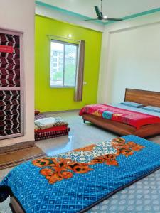 a bedroom with two beds and green walls at Hotel Prem Bhawan in Khātu +15 photos