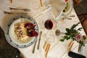 a white table with a plate of food on a table at Hotel San Crispino in Morrovalle