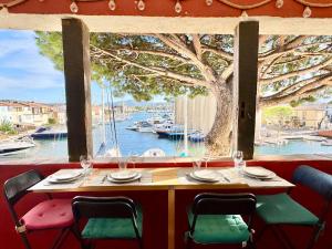 a table in a restaurant with a view of a harbor at L'OCTOGONE in Grimaud