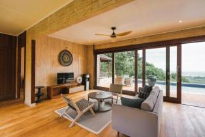 a living room with a couch and a table at Selong Selo Resort and Residences in Selong Belanak