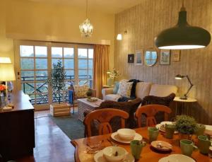 een woonkamer met een bank en een tafel met stoelen bij Green Hill Tanah Rata Cameron Highland in Tanah Rata