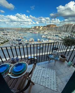 a table and chairs on a balcony with a view of a harbor at CalaMia in Palermo