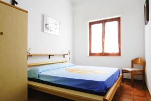 Ένα ή περισσότερα κρεβάτια σε δωμάτιο στο Apartment on Costa Rei near Sandy Beaches
