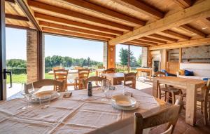 a dining room with a table and a large window at Agriturismo Dolce Colle in Volpago del Montello