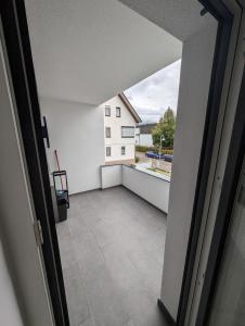 an open door to a balcony with a view of a building at 2 Zimmer Apartment mit Balkon in Eislingen
