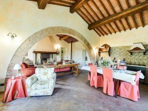 a living room with a table and chairs and a kitchen at Comfortable apartment with stunning views, near hot springs in Celle sul Rigo