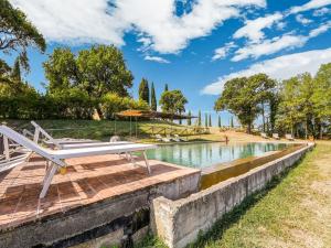 a bench on a boardwalk next to a lake at Comfortable apartment with stunning views, near hot springs in Celle sul Rigo