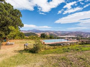 a view of a pool with mountains in the background at Comfortable apartment with stunning views, near hot springs in Celle sul Rigo