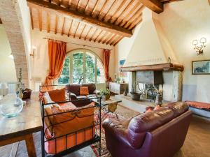 a living room with a couch and a fireplace at Comfortable apartment with stunning views, near hot springs in Celle sul Rigo