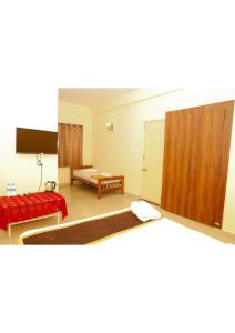 Postel nebo postele na pokoji v ubytování kollanoor guest house