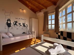 a childs bedroom with a bed with cats on the wall at Villa Desideria in Solin +54 photos