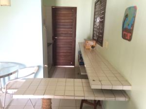 a room with a table and a table and a door at Ekoara Bangalos in Jacumã +23 photos