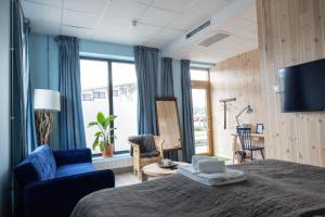 a bedroom with a bed with a laptop on it at Sångbergs Hotell in Tranemo