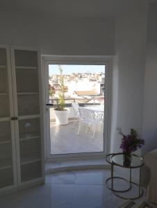 a room with a window with a table and a patio at Sky Santa Cruz Penthouse in Santa Cruz de Tenerife +20 photos