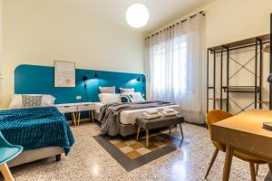 a blue bedroom with a bed and a table at HouSmart Emilia Levante 98 in Bologna