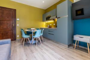 a kitchen and dining room with a table and chairs at HouSmart Emilia Levante 98 in Bologna +41 photos
