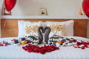 two swans made out of flowers on a bed at Villa Nebula Nearby Soma in Canggu +11 photos