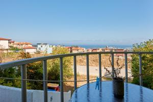 a table on a balcony with a view of the beach at Guest House Dima in Sozopol