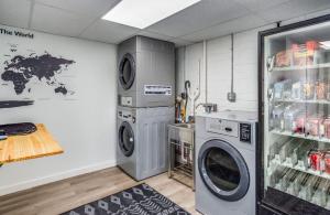 a laundry room with two washing machines and a refrigerator at Newly remodeled bright studio in Rochester