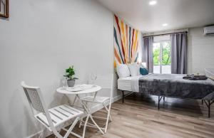 a bedroom with a bed and a table and chairs at Newly remodeled bright studio in Rochester