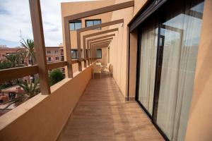 a balcony of a building with glass doors and a corridor at Élégance et Prestige à Gueliz Appartement 3 chambres in Marrakech