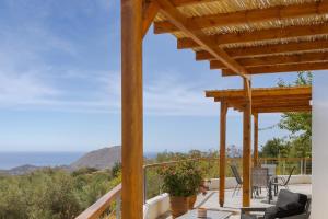 a patio with a view of the ocean from a house at South Akro in Míthoi