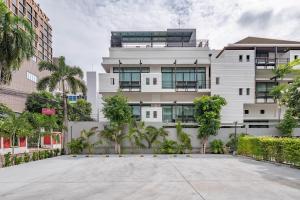 an empty parking lot in front of a building at Luxe Residence in Pattaya Central