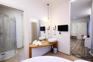 a bathroom with two sinks and a shower at Palazzo Belli in Alba +82 photos