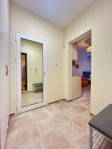 a large mirror in a room with a hallway at Studio 110 by COSHER in Sofia