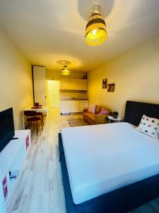 a bedroom with a white bed and a living room at Studio 110 by COSHER in Sofia +2 photos