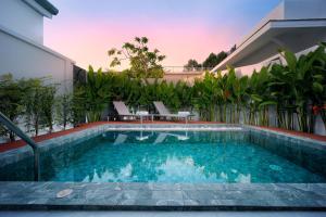 a swimming pool in the backyard of a house at Barringtonia pool villa in Nai Yang Beach