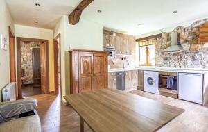 a kitchen with a wooden table in a room at La Tienda de Abajo - Apartamentos para familias con parking privado y vistas al Valle de Soba in Villar