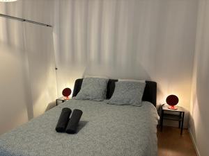 a bedroom with a bed with two pillows on it at Les Studios de Clément in Poitiers