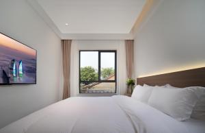 Llit o llits en una habitació de 贵客心宿 Xiamen Guike Xinsu