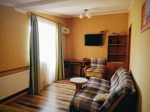 a living room with a couch and a table at Apartment on Hoholya 90 in Kropyvnytskyi