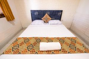 Postel nebo postele na pokoji v ubytování Apartmen Kak Okoh