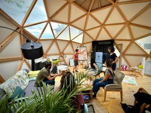 a group of people sitting in a yurt at O'Chambon in Chambon-sur-Lac