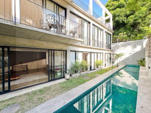 a house with a swimming pool in front of it at Vila Amorim - Art Residency in Rio de Janeiro