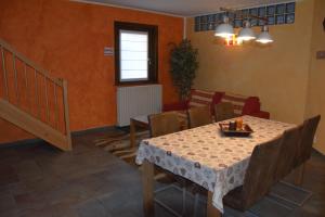 a dining room with a table and chairs and a couch at Chalet Rin Star in Livigno