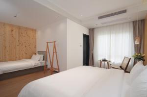 Llit o llits en una habitació de 贵客心宿 Xiamen Guike Xinsu