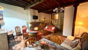 a living room with a couch and a fireplace at Casa Rural el Comercio Sierra de Francia in San Miguel de Valero