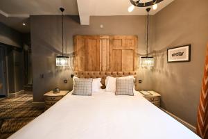 a bedroom with a large bed with two pillows at The King's Head in Beverley +19 photos