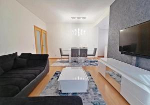 a living room with a couch and a table at Douro Residence Porto Gaia in Vila Nova de Gaia