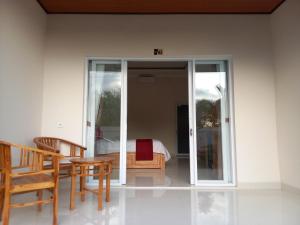 a room with a bed and a table and chairs at Prayoga homestay in Nusa Dua +25 photos