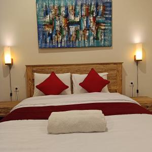 a bedroom with a large bed with red pillows at Prayoga homestay in Nusa Dua +25 photos