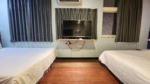 Voodi või voodid majutusasutuse Yung Feng Hotel toas