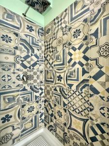 a bathroom with blue and white tiles on the wall at private spa in historic villa with pool in Senigallia in Senigallia +29 photos