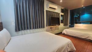 Voodi või voodid majutusasutuse Yung Feng Hotel toas