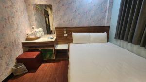Voodi või voodid majutusasutuse Yung Feng Hotel toas